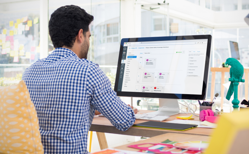 Man sitting at computer with Canvas app on computer