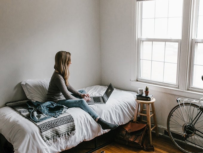 Woman on bed using computer