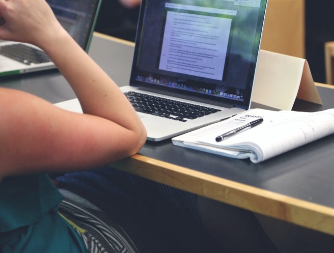 student sitting in front of laptop